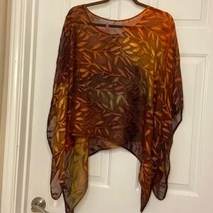 Poncho style, sheer top with handkerchief sides. Warm browns/golds/greens